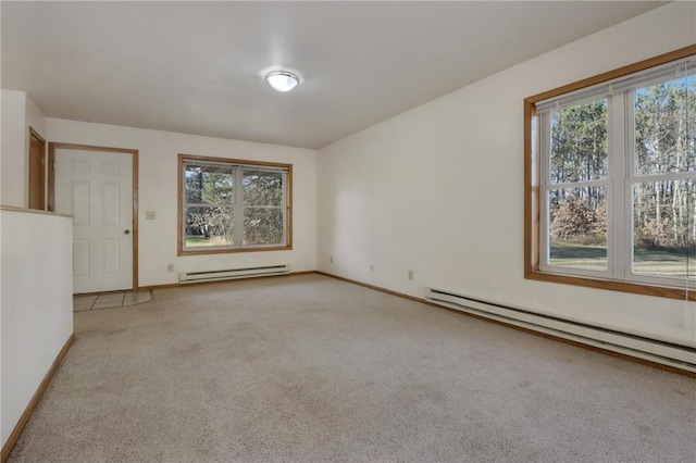 empty room featuring light colored carpet and a baseboard radiator