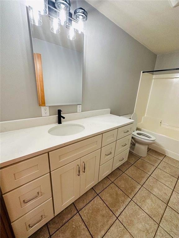 full bathroom with tile patterned flooring, vanity, toilet, and tub / shower combination