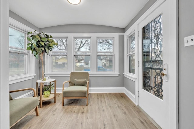 sunroom / solarium featuring vaulted ceiling