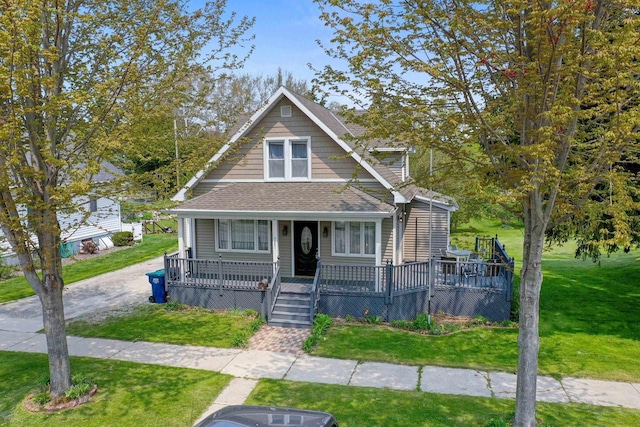 bungalow with a porch and a front lawn