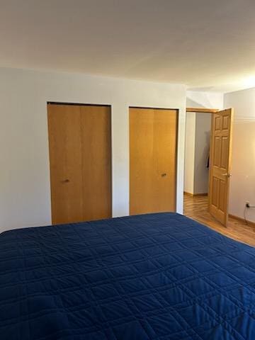 unfurnished bedroom featuring multiple closets