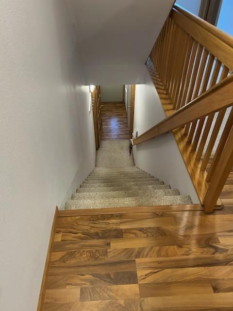 stairs featuring wood-type flooring