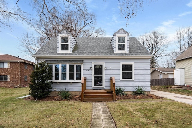 cape cod-style house with a front yard