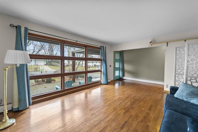 living room with hardwood / wood-style floors and baseboard heating