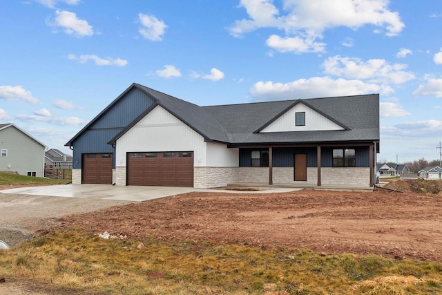 modern inspired farmhouse with a garage and a porch