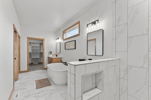 bathroom with vanity and a tub