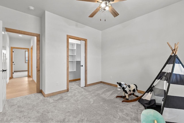 interior space featuring light colored carpet and ceiling fan