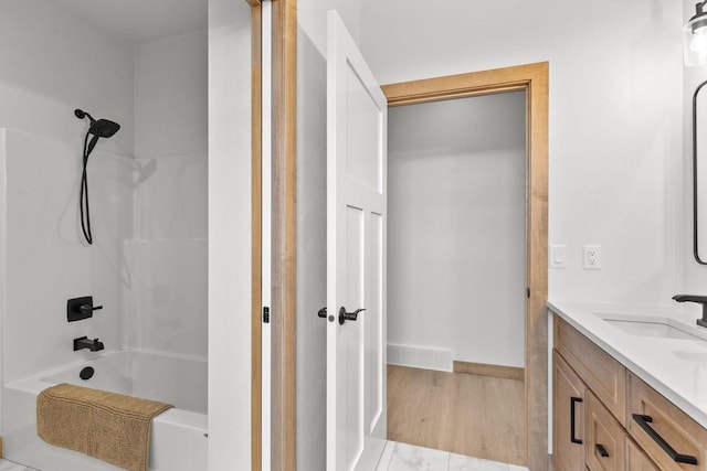 bathroom with hardwood / wood-style flooring, vanity, and bathtub / shower combination