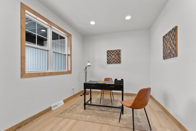 office space with wood-type flooring