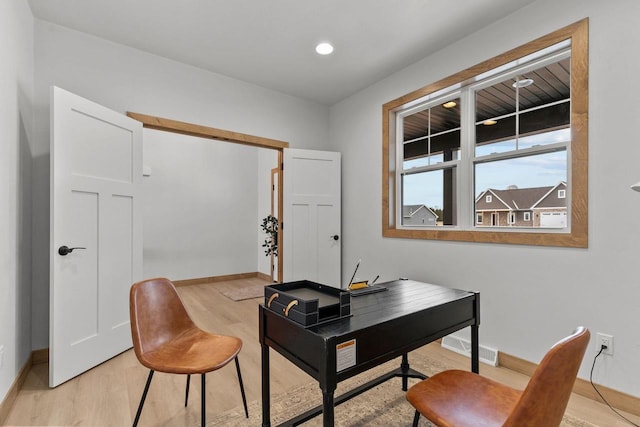 office with light wood-type flooring