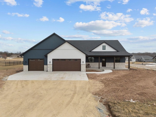 modern inspired farmhouse featuring a garage and covered porch