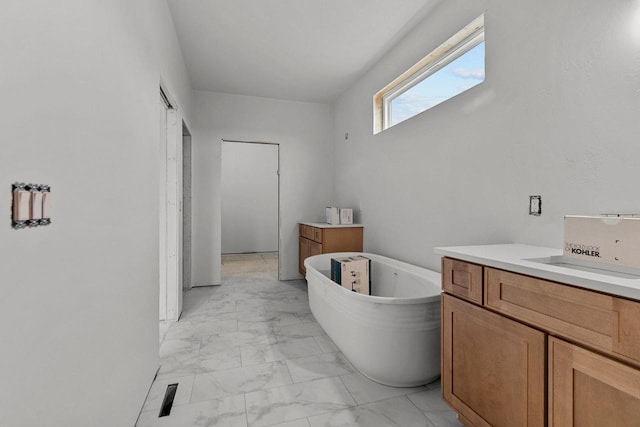 bathroom featuring vanity and a bath