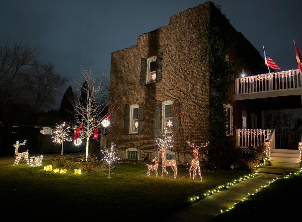 back house at night with a lawn