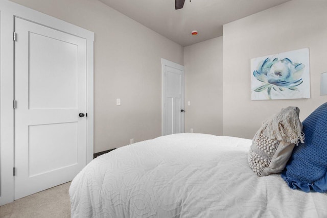 carpeted bedroom with ceiling fan