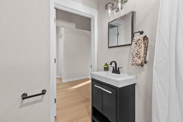 bathroom with vanity and wood-type flooring