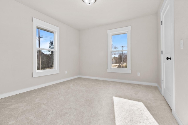 carpeted spare room with plenty of natural light