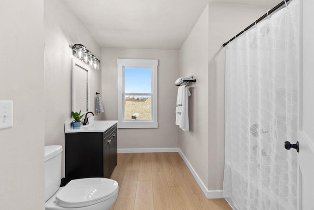 bathroom with wood-type flooring, vanity, toilet, and a shower with curtain