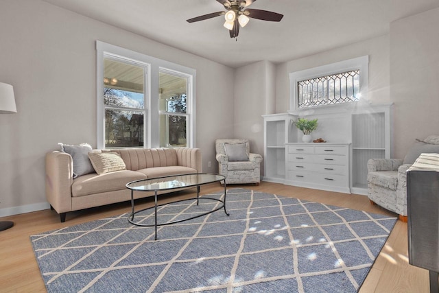 living room featuring wood-type flooring, plenty of natural light, and ceiling fan