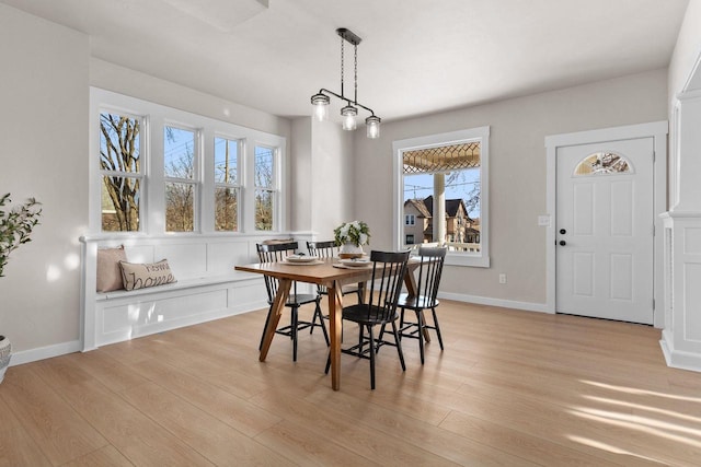 dining room featuring an inviting chandelier and light hardwood / wood-style flooring