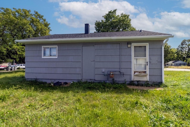 view of outbuilding with a yard