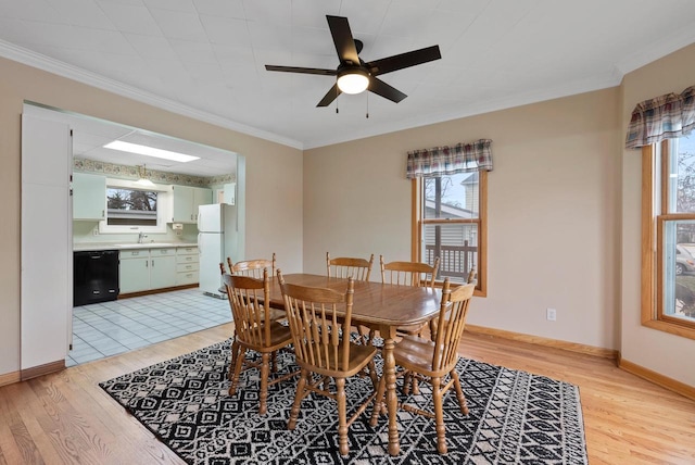 dining area featuring plenty of natural light, crown molding, and light hardwood / wood-style flooring