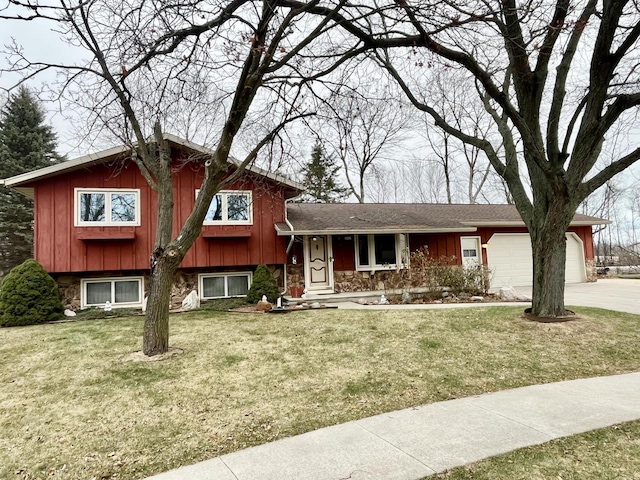 tri-level home featuring a garage and a front yard