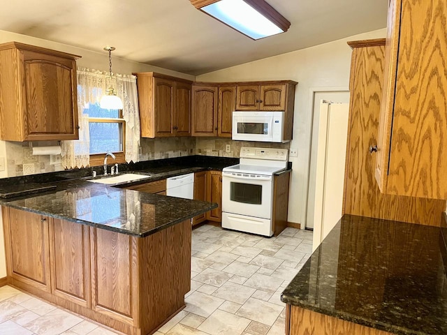 kitchen featuring kitchen peninsula, dark stone counters, white appliances, sink, and lofted ceiling