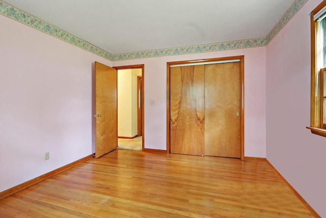 unfurnished bedroom with light hardwood / wood-style floors and a closet