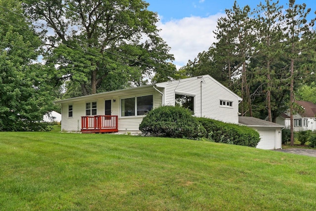 view of front of house with an outbuilding, a front lawn, and a garage