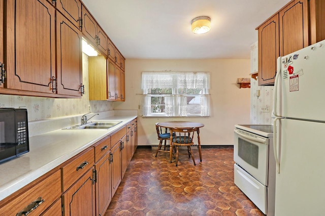 kitchen featuring white appliances and sink