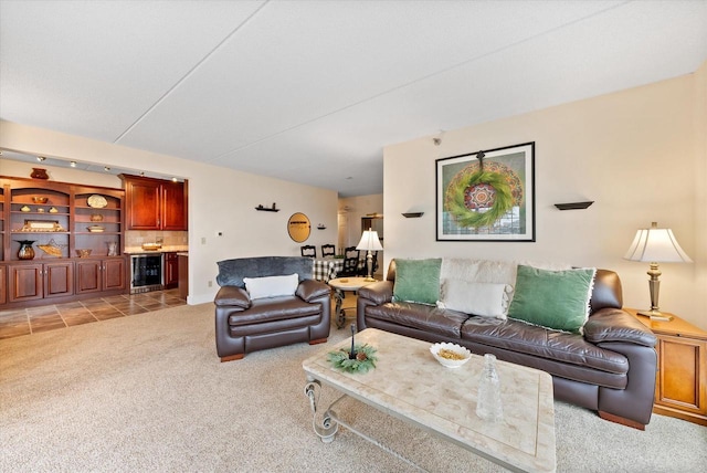 living area with light carpet, wine cooler, and a dry bar