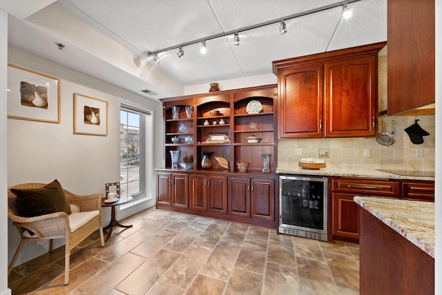 bar featuring tasteful backsplash, wine cooler, visible vents, and a textured ceiling