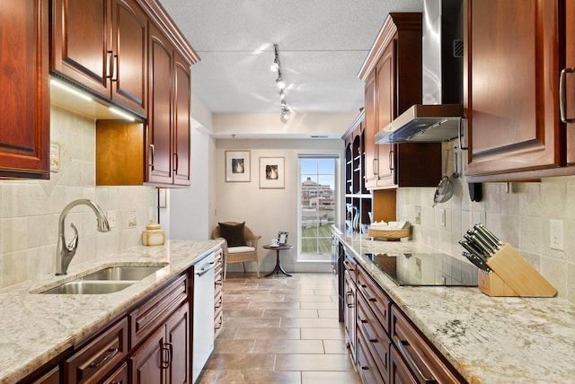 kitchen with dishwasher, a sink, wall chimney exhaust hood, and light stone countertops