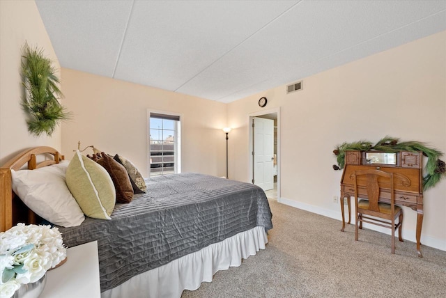 bedroom featuring carpet floors, visible vents, and baseboards