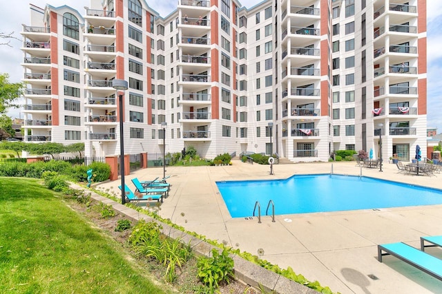 community pool featuring fence and a patio