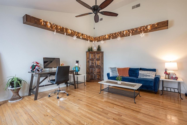 office area with light hardwood / wood-style floors, high vaulted ceiling, and ceiling fan