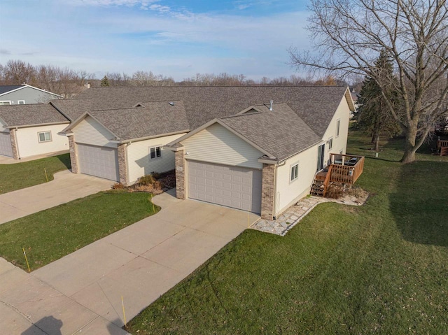 ranch-style house featuring a garage, a front lawn, and a deck