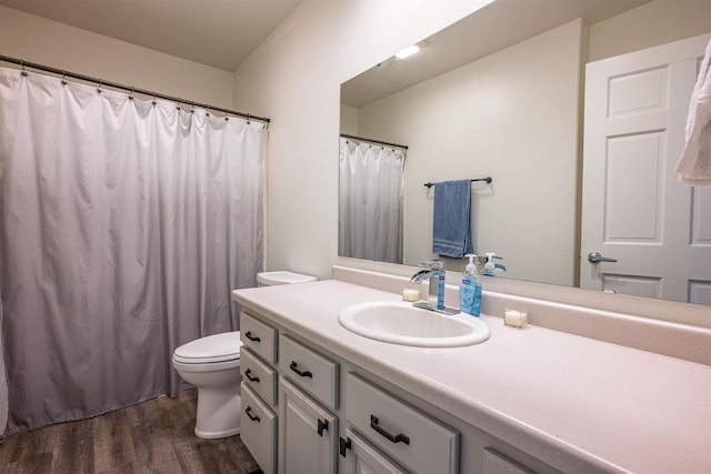 bathroom with vanity, hardwood / wood-style flooring, and toilet