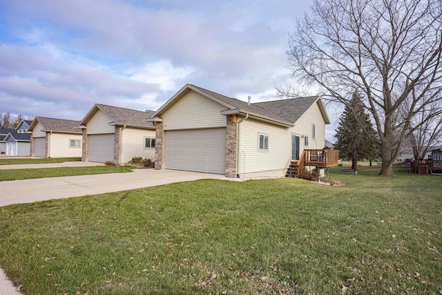 view of front of home with a garage, a front yard, and a deck