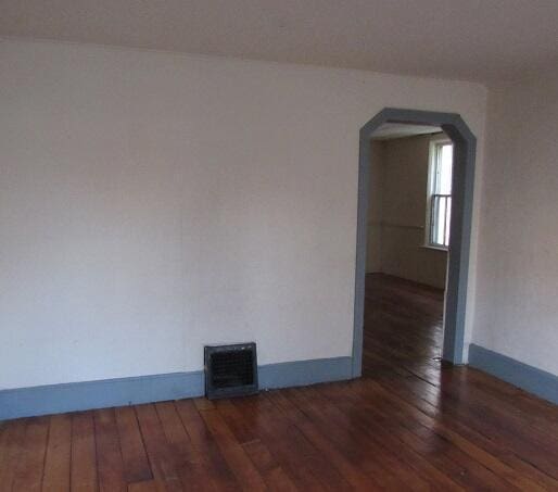 unfurnished room with dark hardwood / wood-style flooring