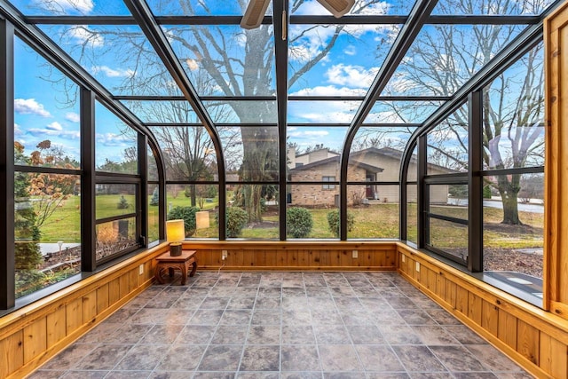 unfurnished sunroom featuring ceiling fan