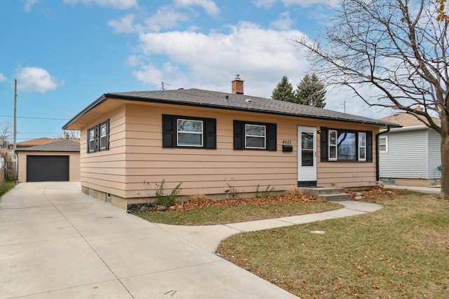 view of front of house featuring an outbuilding, a front yard, and a garage