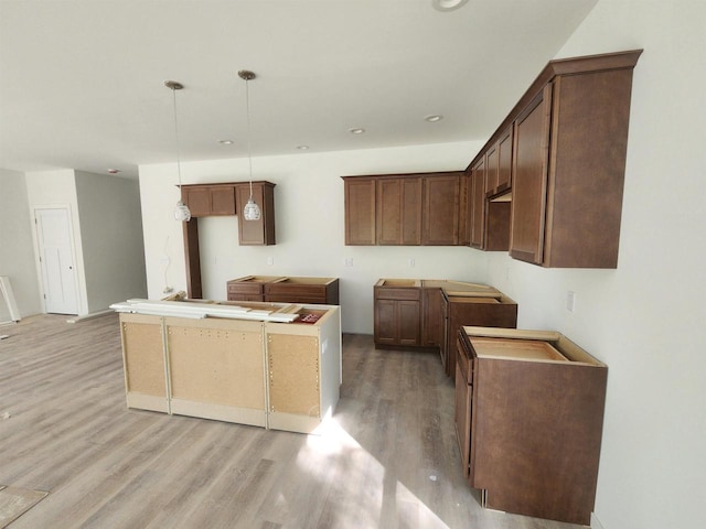 236 Russell Ct, Jefferson, WI 53549 - kitchen with light wood finished floors, a center island, hanging light fixtures, and recessed lighting