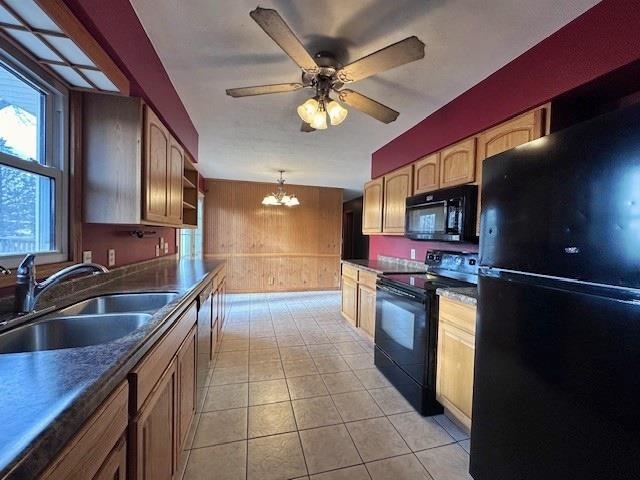 803 E Birch St, Spencer, WI 54479 - kitchen with sink, decorative light fixtures, light tile patterned floors, black appliances, and ceiling fan with notable chandelier