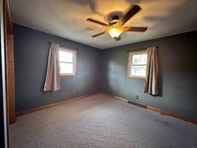 803 E Birch St, Spencer, WI 54479 - spare room featuring carpet, ceiling fan, and a healthy amount of sunlight