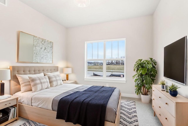 bedroom featuring light colored carpet