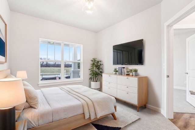 bedroom with baseboards and wood finished floors