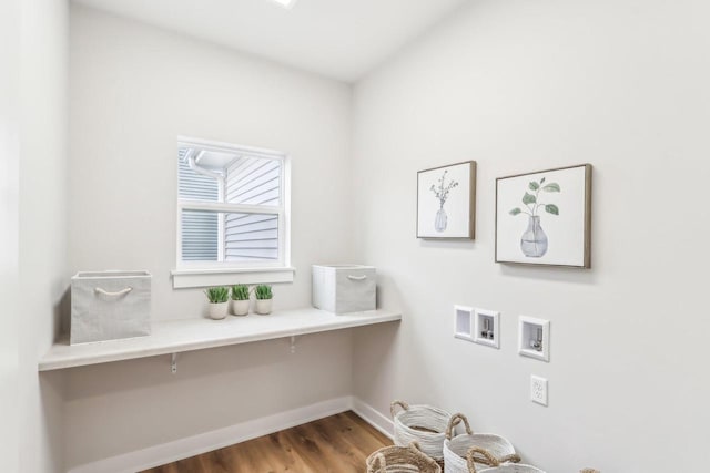 laundry room featuring hookup for a washing machine, laundry area, baseboards, and wood finished floors