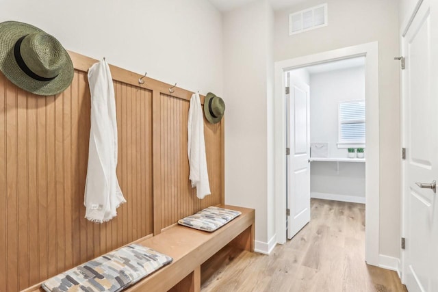 mudroom with light wood-type flooring, baseboards, and visible vents