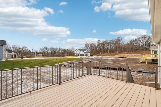 wooden terrace with a lawn